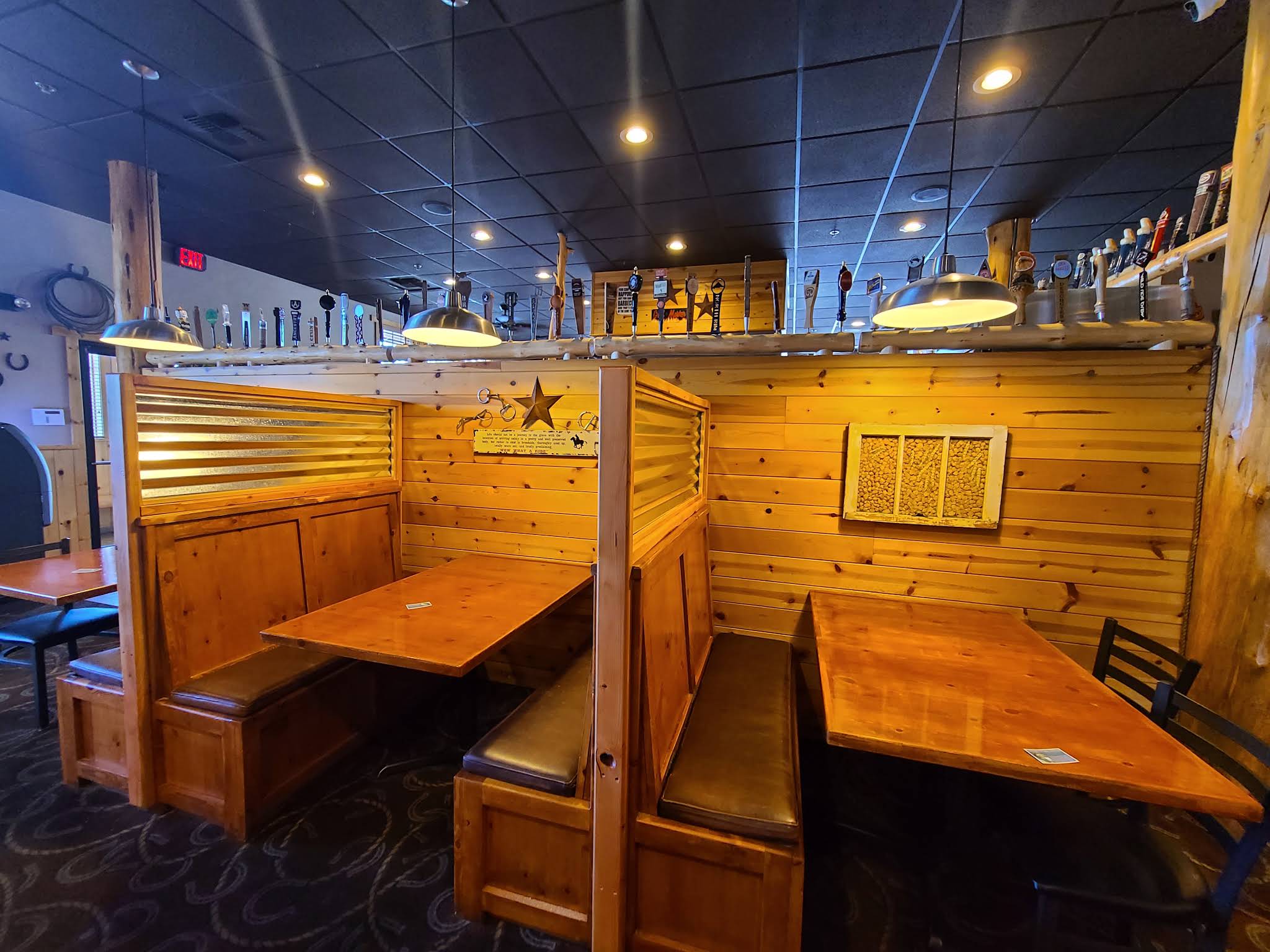 Wooden booths, pendant lights and tap handles inside Dillon’s Grill in Prineville