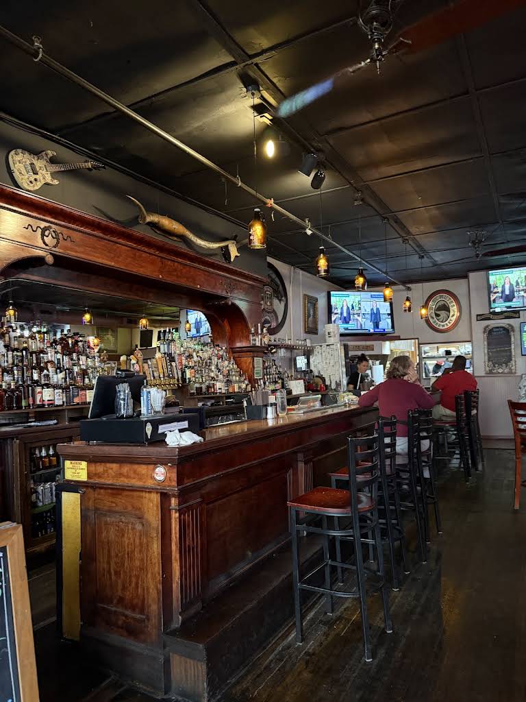 Wooden bar and hanging lights inside Mac’s Place in Silverton
