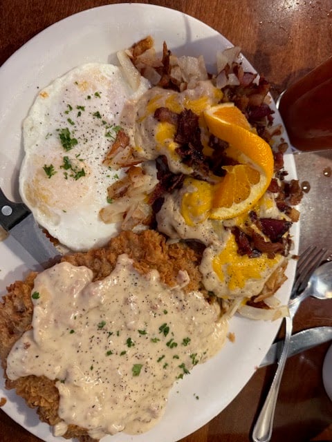 Chicken-fried steak, sausage gravy, eggs, and loaded potatoes at Brick & Mortar Cafe. Bring an appetite.