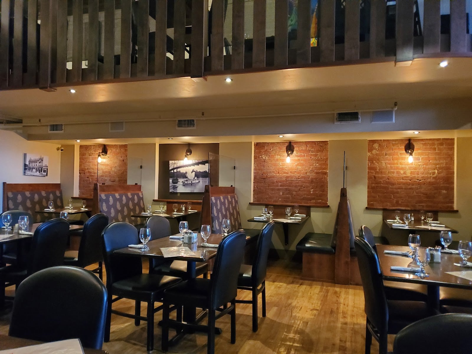 Tables, wood floors, and brick walls inside Brick & Mortar Cafe.