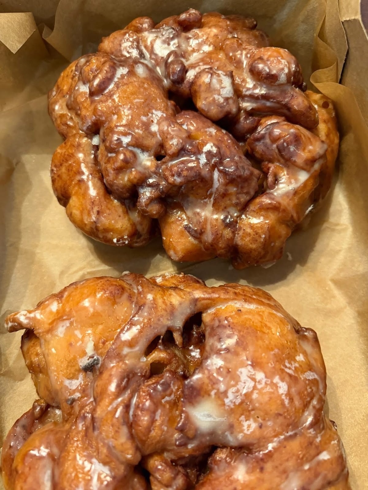 A glazed apple fritter photographed at Sisters Bakery in September 2026.