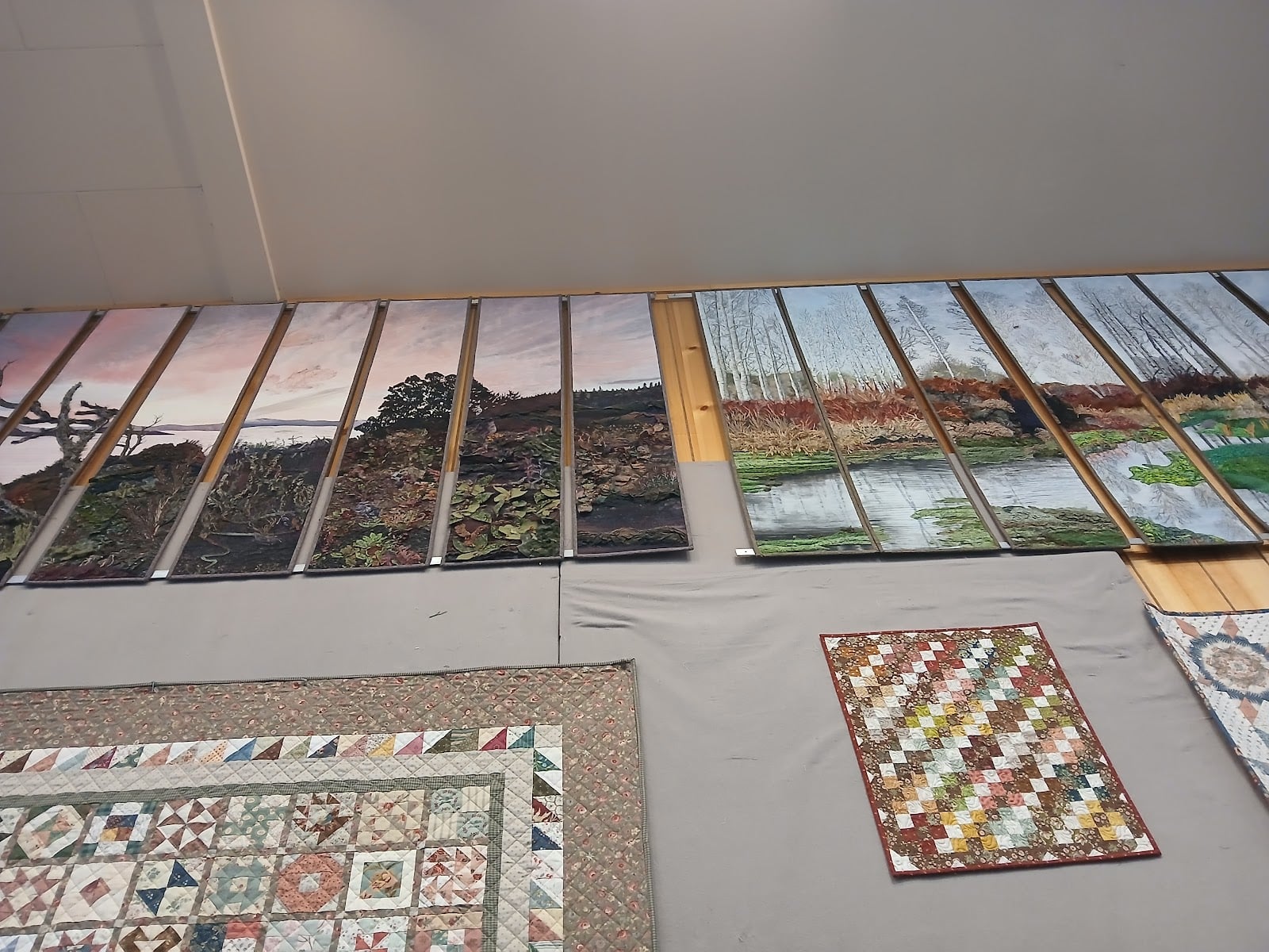 Landscape panels and smaller quilts add variety to the wall displays.