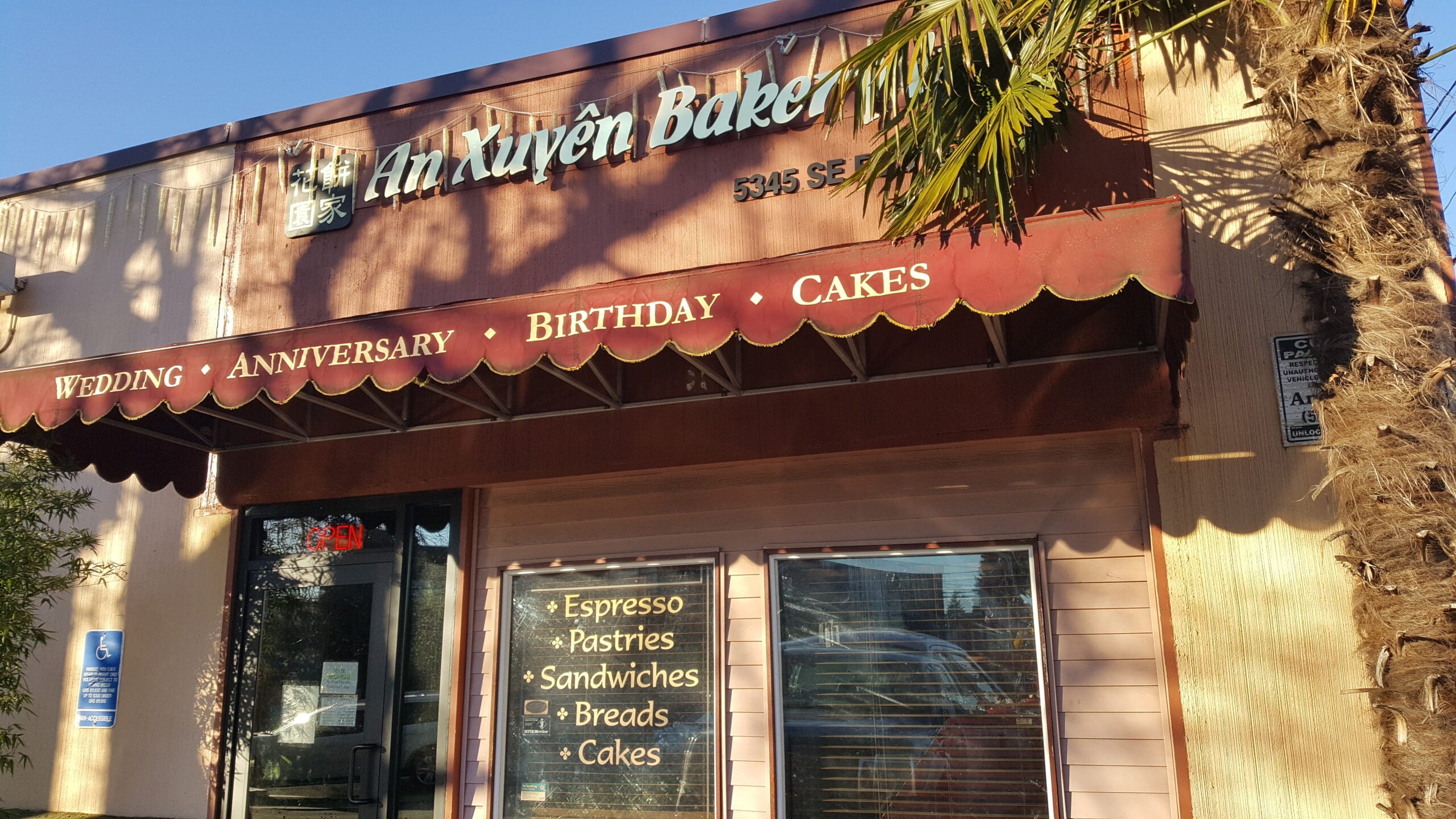 An Xuyên Bakery’s Foster Road storefront, photographed in January 2022 An Xuyên Bakery sign above the red awning and entrance on Foster Road