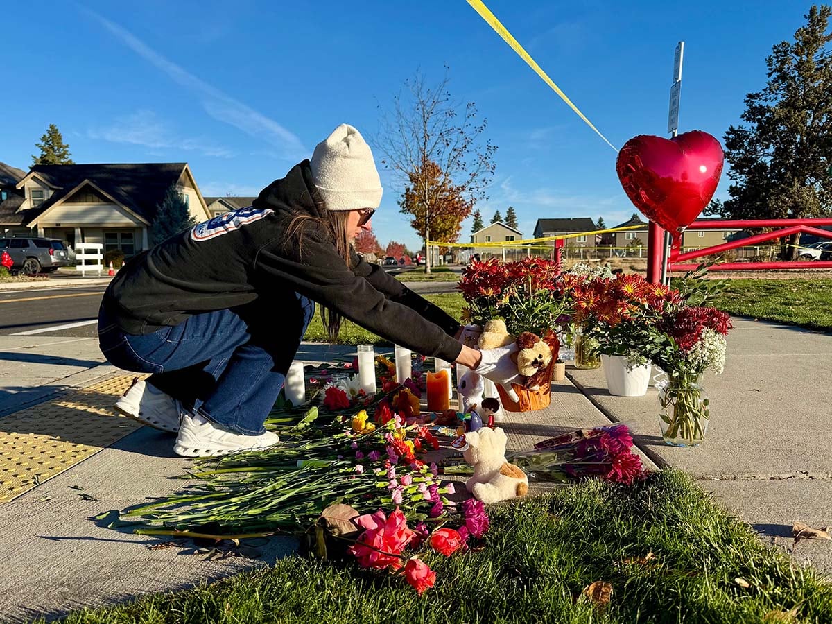 Oregon School Shooting A person places flowers at a makeshift memorial outside Silver Rail Elementary School in Bend, Oregon.