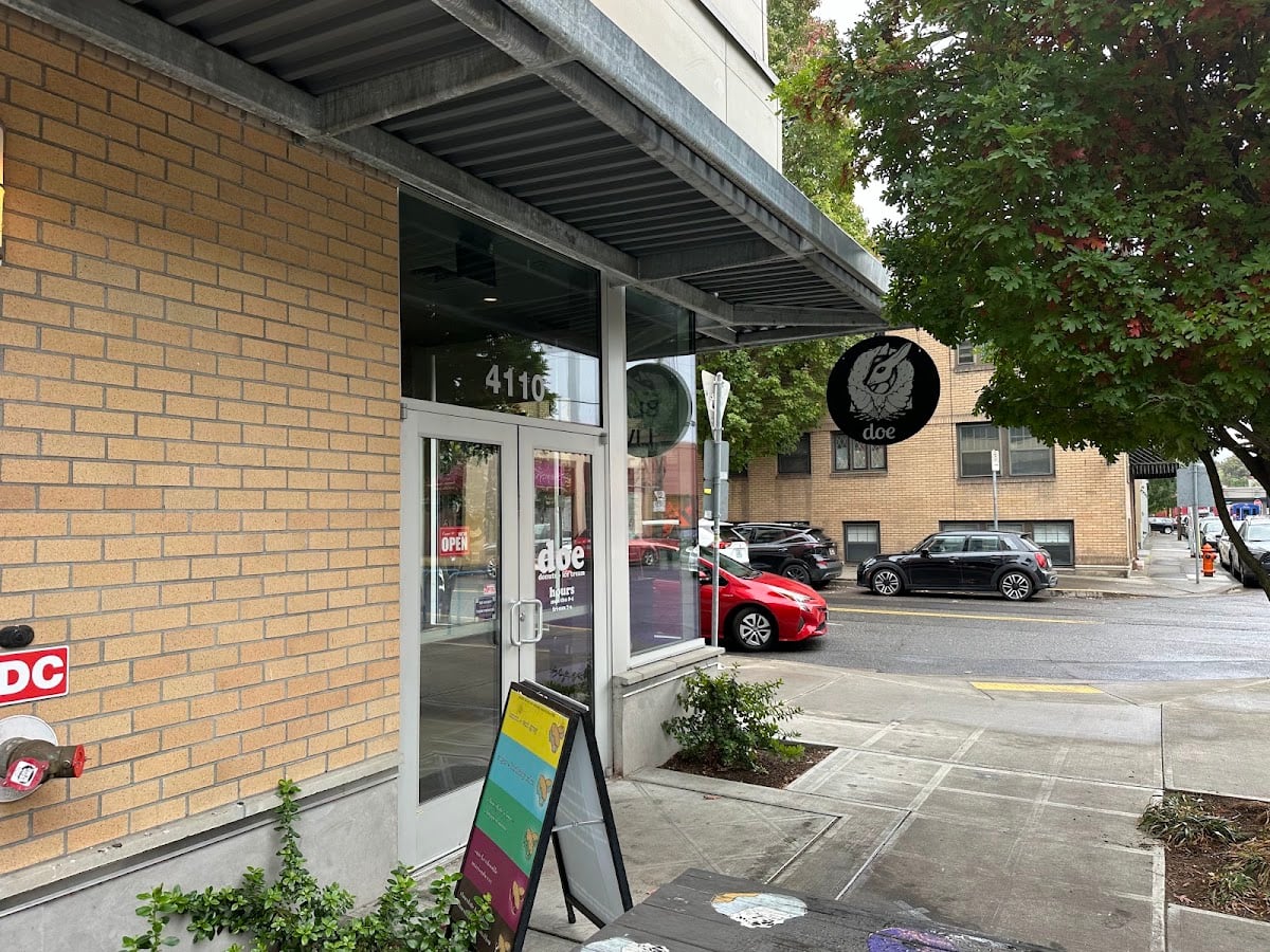 Doe Donuts Portland feature Brick storefront and glass entrance of Doe Donuts at 4110 NE Sandy Boulevard.