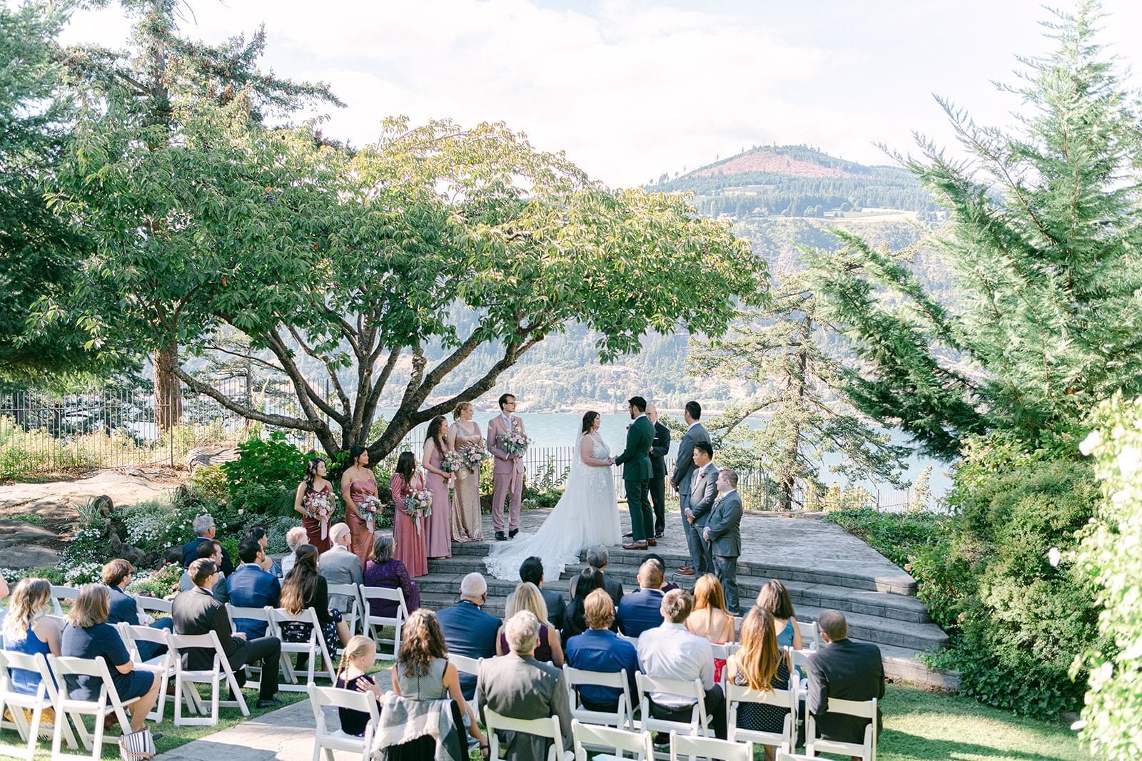 Guests watch a wedding ceremony overlooking the Columbia River at Columbia Gorge Hotel.