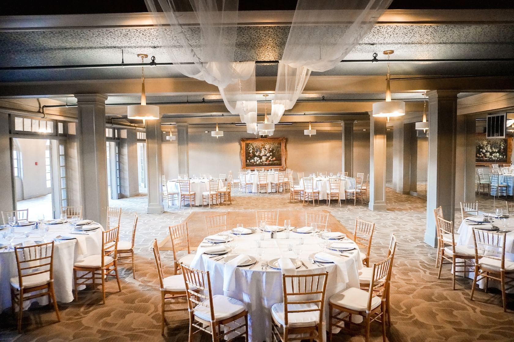 Benson Ballroom set with round dinner tables and ceiling drapery.
