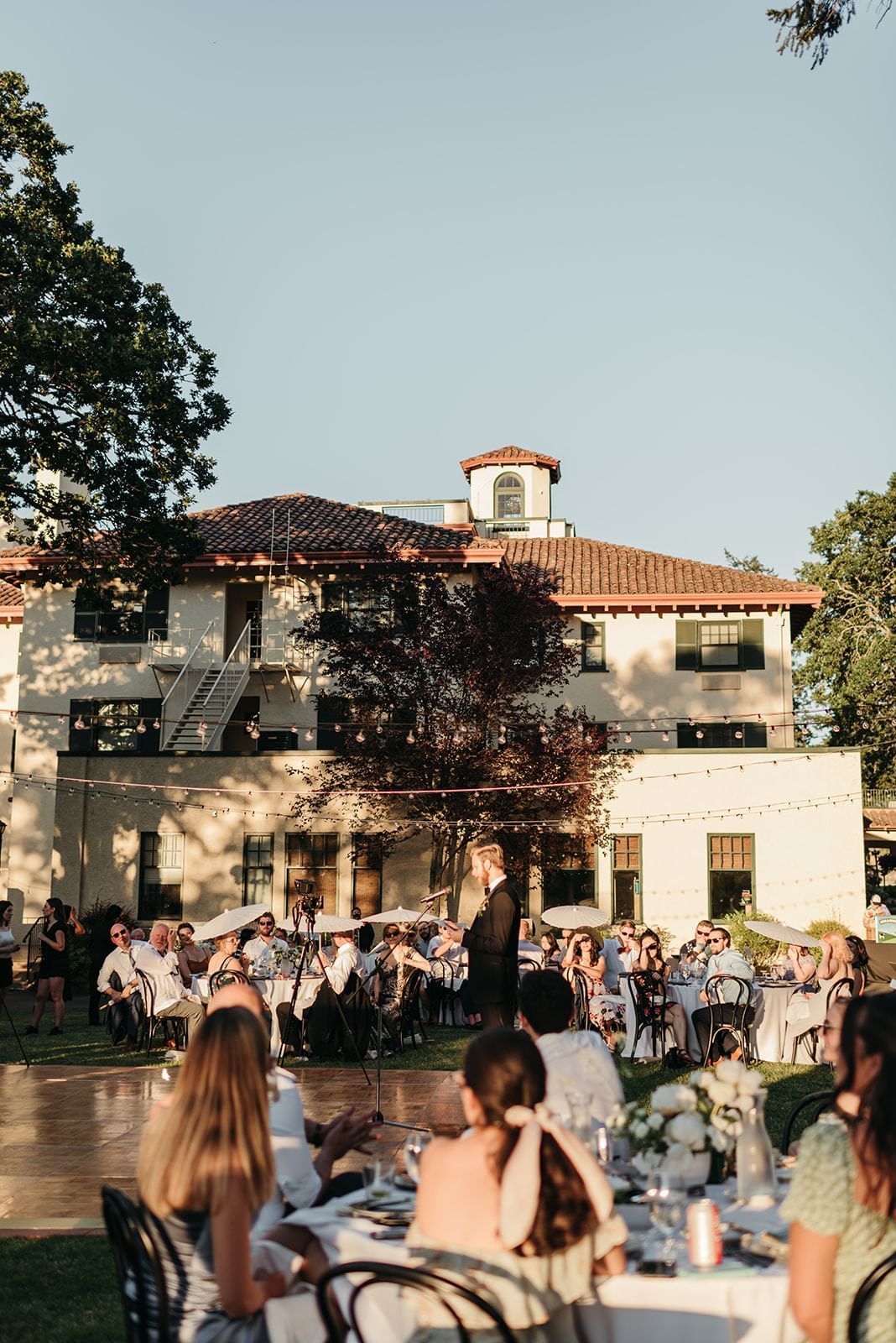 Outdoor wedding reception with Columbia Gorge Hotel in the background.