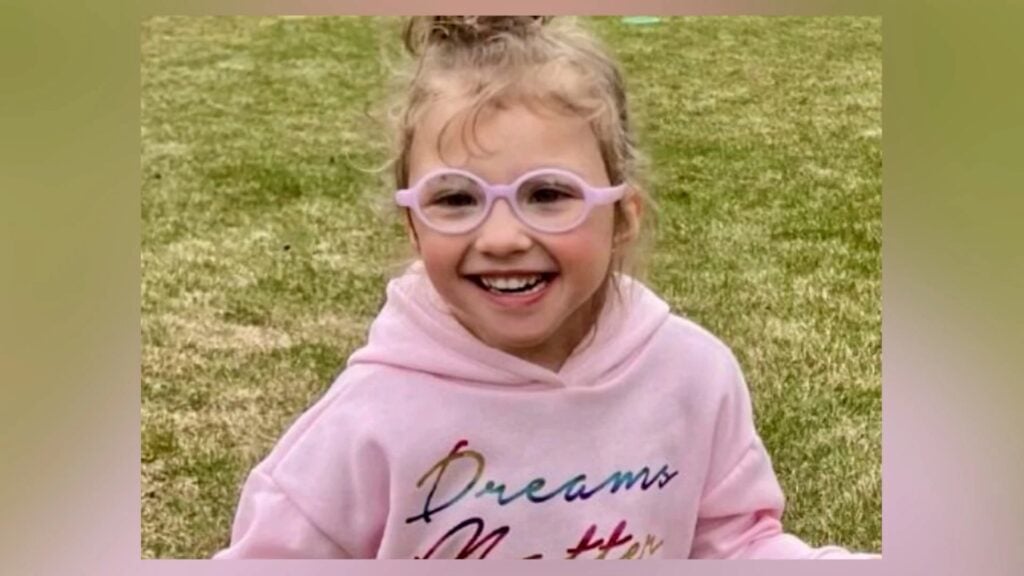 Saylor Graham-Poarch smiling outdoors in pink glasses and a pink hoodie in a previously shared photograph.