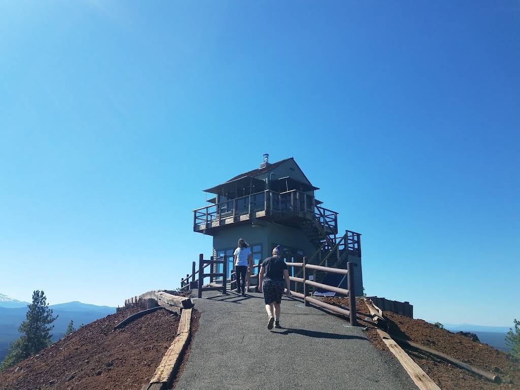 Lava Butte fire lookout above a paved path and red cinder slopes