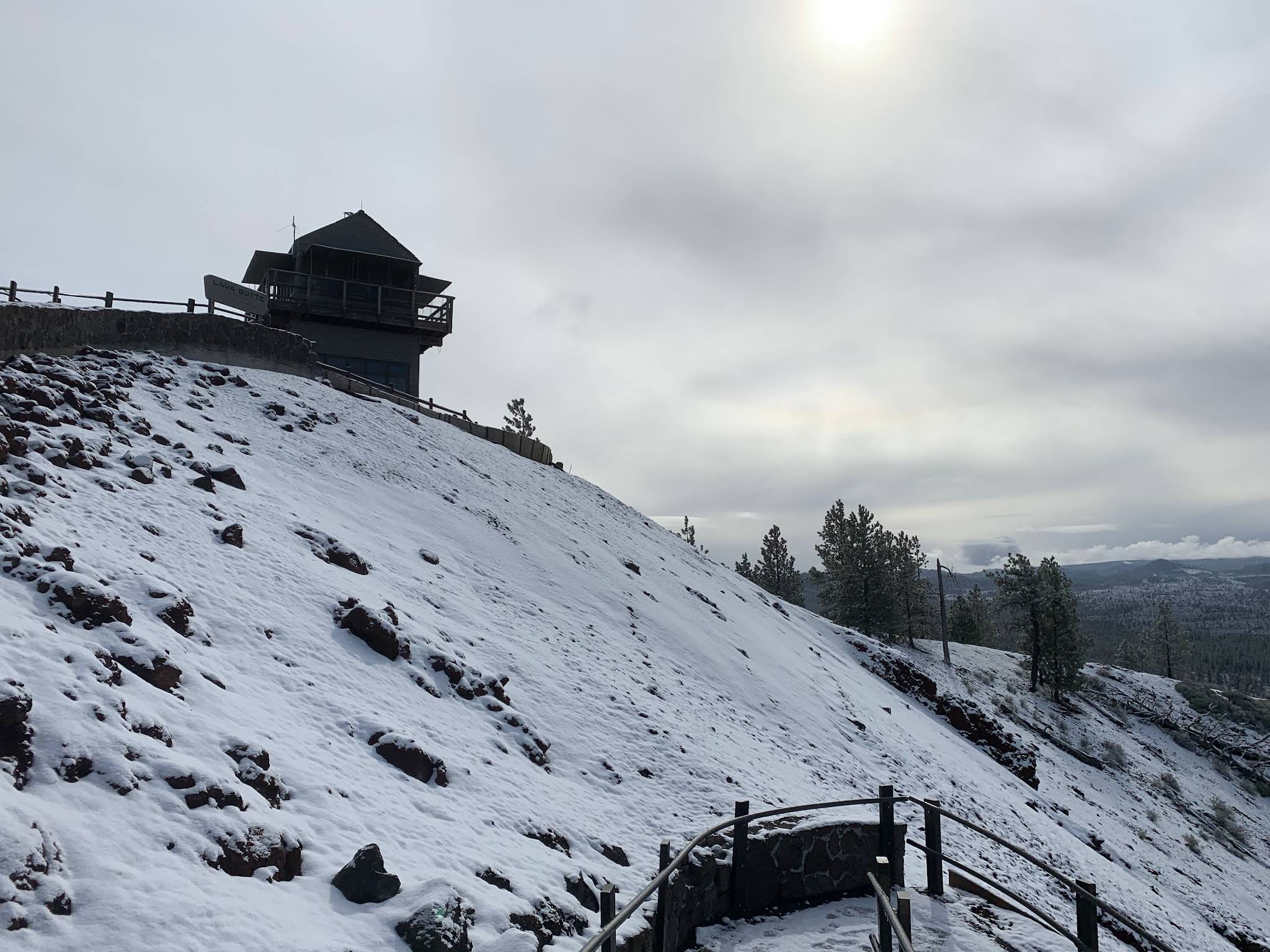 Snow covering Lava Butte’s cinder slopes below the summit fire lookout
