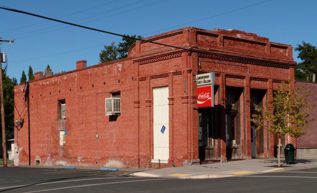Red brick Saling and Reese Store building with a Longbranch Cafe and Saloon sign in Weston
