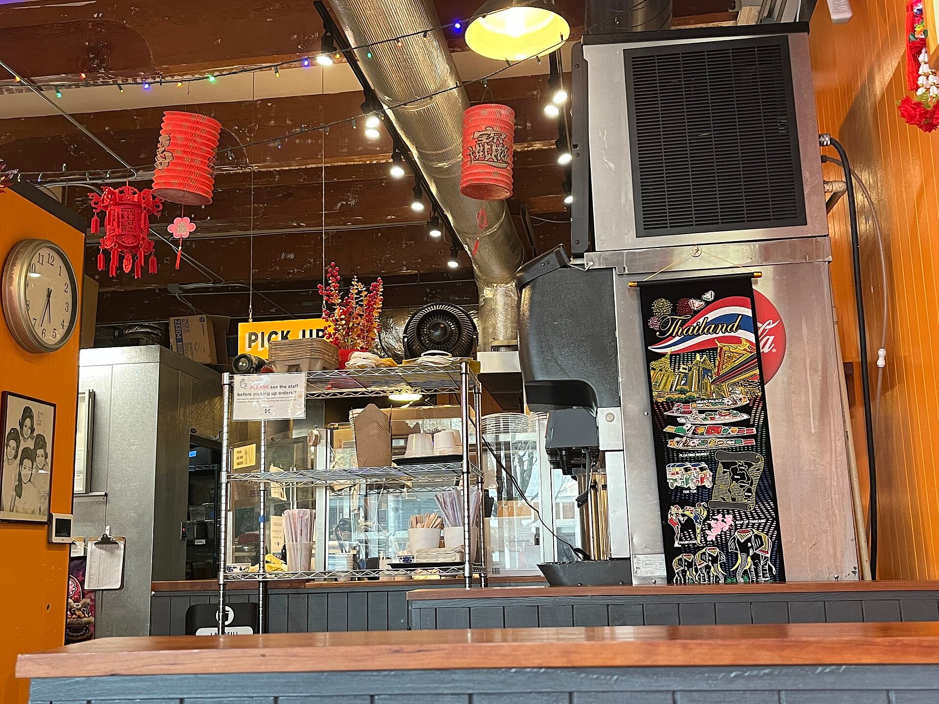 Restaurant counter and seating beneath red lanterns at Nong’s Khao Man Gai