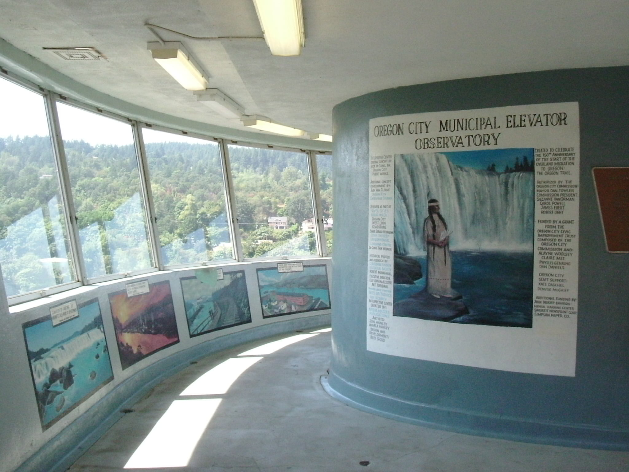 Curving observation deck with windows and historic display panels