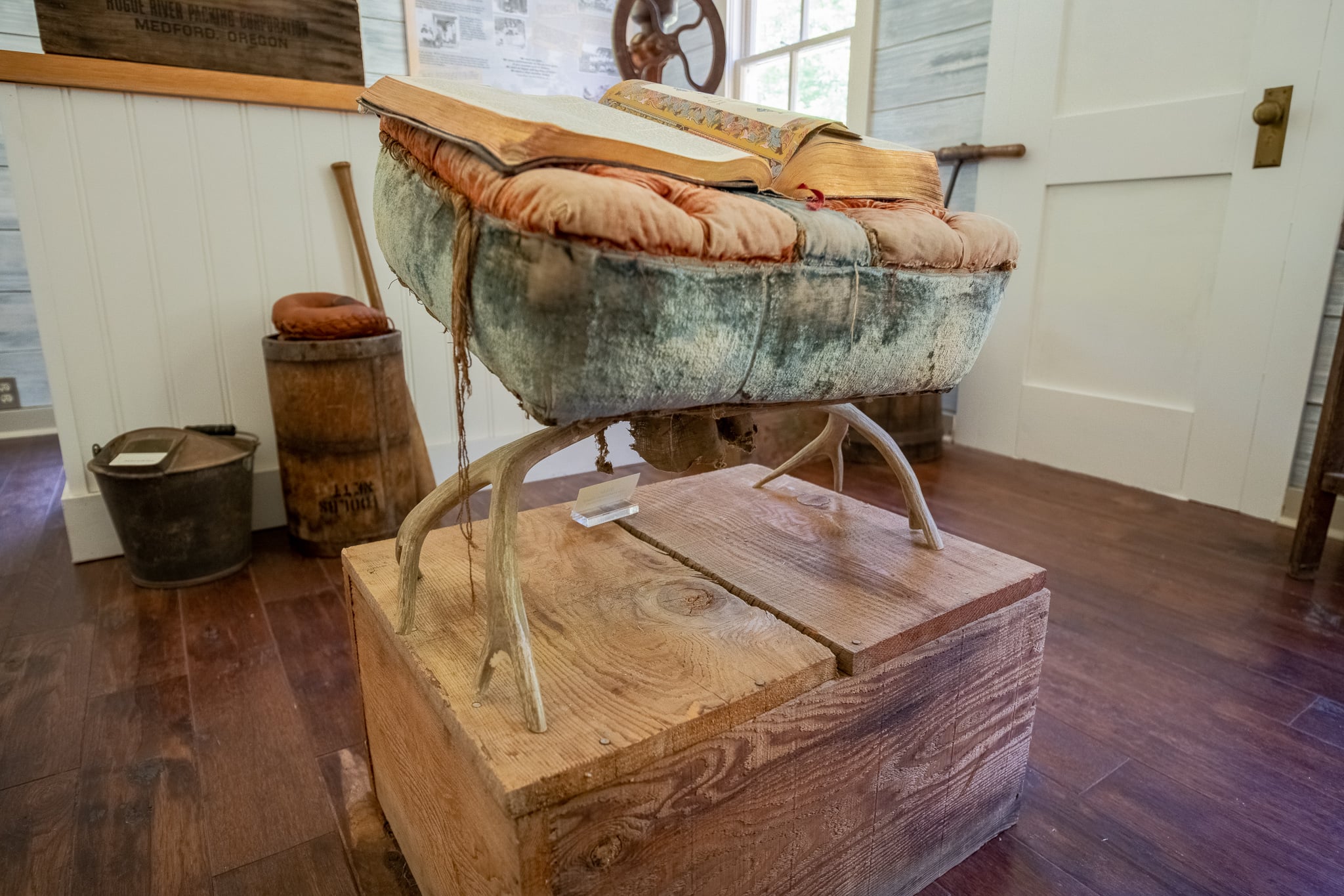 Woven basket mounted in a display inside the Rogue River Ranch museum