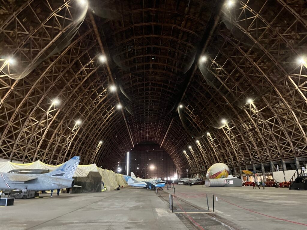Historic aircraft beneath the enormous timber roof of Hangar B at Tillamook Air Museum